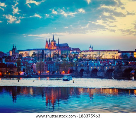 Vintage retro hipster style travel image of travel Prague Europe concept background - view of Charles Bridge and Prague Castle in twilight. Prague, Czech Republic