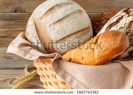 Composition of various baked products in basket on rustic background. Homemade fresh pastry