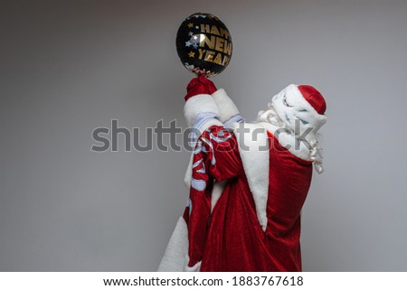 picture of old santa claus holds a baloon with wishes in his hands