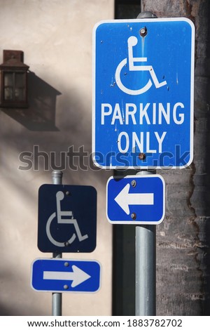 Close-up view of to signs for a special handicap disability parking spot