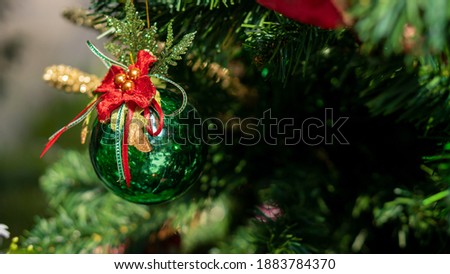 Green glass ball ornaments decorated on the christmas tree