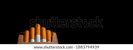 Detail of cigarette isolated on black background. Close-up macro shot. Banner panoramic. Copy space for text message.