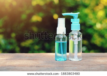 close up plastic bottle of alcohol gel and hand spray on wood table, copy space background for text, 2019-ncov risk and problem, coronavirus covid-19 warning, healthcare and new normal lifestyle