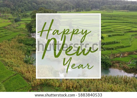 Green word Happy New Year lettering with landscape view background. Greeting card design template