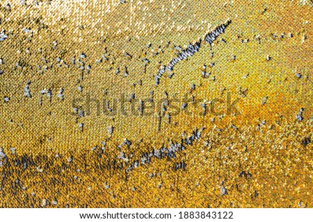 Luxury background made of golden spangles in close-up.