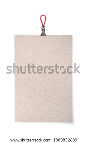 Sheet of paper with binder clips isolated on a white background