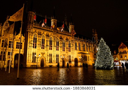 A Christmas tree and colourful lights in Brugge' city centre. Lights and decorations for Christmas holidays.A night landscape of Brugge, Belgium. High quality photo