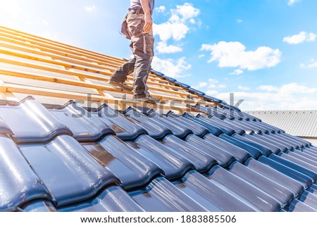 craftsman treasure a fired ceramic tile on the roof Royalty-Free Stock Photo #1883885506