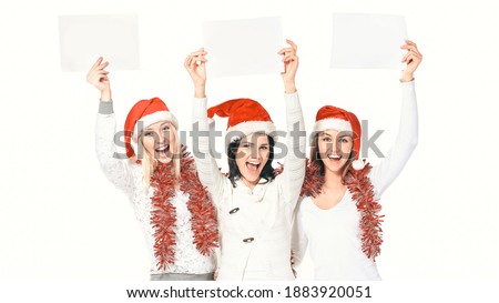 group of female students in costumes of Santa Claus holding blank sheets