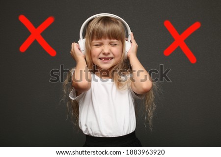 Annoyed stressed girl cover ears feel hurt ear ache pain otitis suffer from loud noise sound headache, irritated stubborn girl deaf hear not listen to noisy music isolated on gray studio background Royalty-Free Stock Photo #1883963920