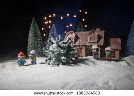 Celebrating winter and Christmas holidays in the new Covid-19 reality. Traditional holiday attributes and covid novel on snow. Creative artwork decoration. Merry healthy Christmas