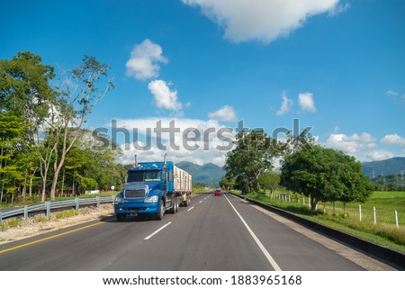 Truck loading merchandise on a Colombian highway Royalty-Free Stock Photo #1883965168