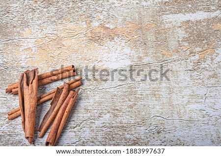 cinnamon on rustic background (rustic)