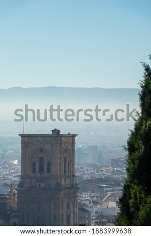 A walk in Granada: Detail of the bell tower of the cathedral of Granada seen from a viewpoint of the Albaicin
