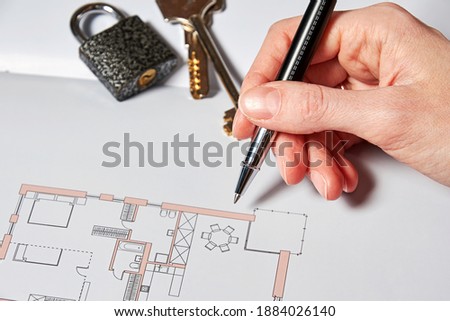 Man hand with a pen sign a real estate deal contract. Concept and symbols of property sales