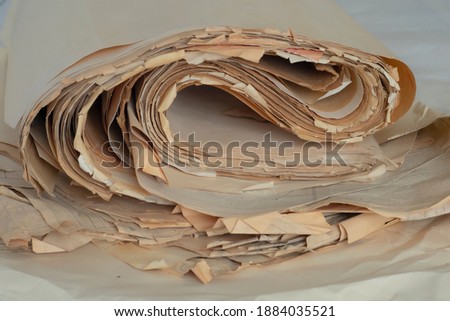 Old, randomly folded paper, as waste paper.