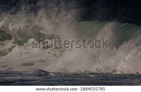 Close-up color image of wave breaking following a high sea