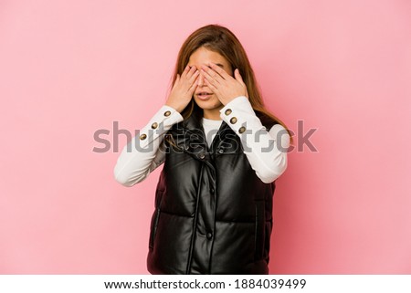 Young skinny caucasian teenager girl afraid covering eyes with hands.