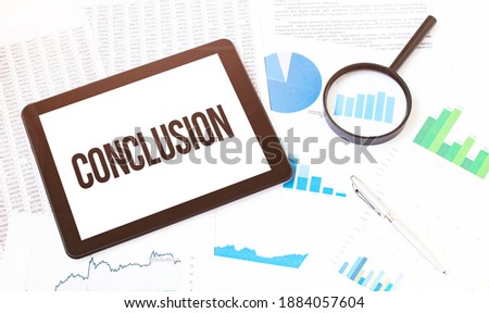Cropped image of businessman examining graph on digital tablet with magnifying glass at office desk. Text Conclusion