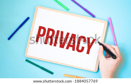 Text PRIVACY on a notebook surrounded by colored felt-tip pens, business concept idea,