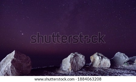 Milkyway galaxy and stars in the sky and Pacific ocean view