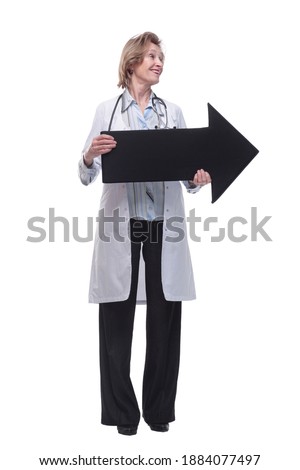 Friendly senior medical doctor pointing direction with arrow