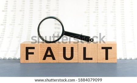 Wooden blocks with the text: fault. Fault word made with building blocks, business concept