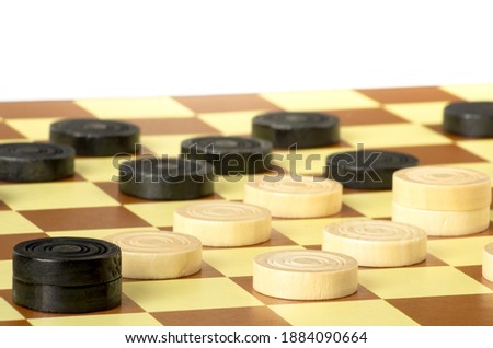 checkers or draughts is a board game. Close Up of wooden round checkers. white background with space for text