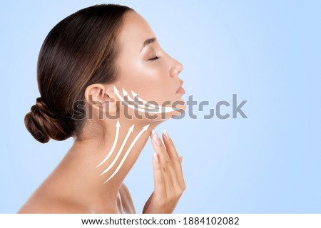 Pretty woman touching her neck, light blue background.. Anti-aging concept.	 Royalty-Free Stock Photo #1884102082