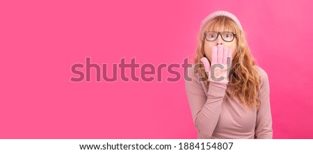 adult woman wearing warm clothes and surprised expression isolated