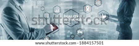 QA Businessman pressing Quality assurance button on virtual screens. Royalty-Free Stock Photo #1884157501