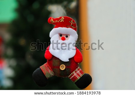 Toy little Santa Claus. A souvenir, a Christmas present. A small toy. For a postcard. Free space, empty space.
