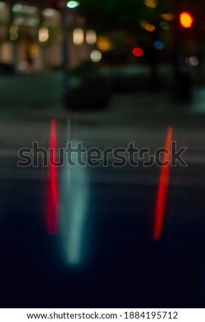 Street lights reflected off metal create a blurred bokeh artistic effect on the camera lens in downtown Austin.