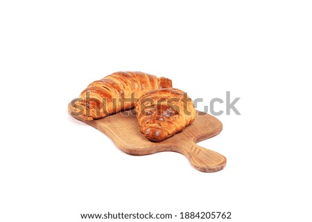 Fresh croissants isolated on a white background. Breakfast with Fresh pastry.Candies and sweets. Croissants on a cutting board.