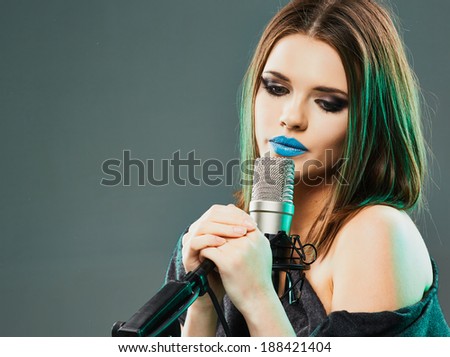 Singing star. Woman singer portrait. Sound studio.