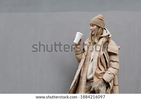 Woman drinking coffee outdoor. Color of the year 2021: ultimate gray. Trendy colors concept, mockup with copy space Royalty-Free Stock Photo #1884216097
