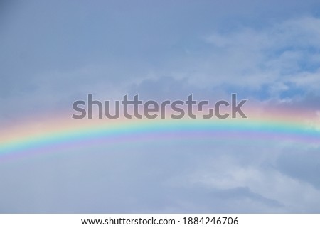 Brilliant rainbow appears across a moody sky in Cottonwood, FL