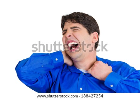 Closeup portrait, really stressed, unhappy young heavy man with really bad neck pain, after long hours of work, studying, isolated white background. Negative human emotions, facial expressions