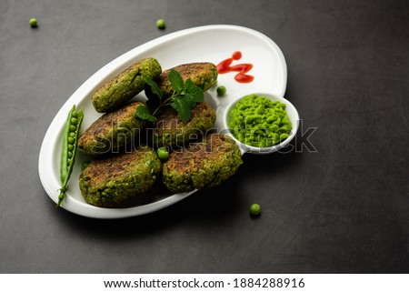 Hara bhara Kabab or Kebab is Indian vegetarian snack recipe served with green mint chutney over moody background. selective focus Royalty-Free Stock Photo #1884288916