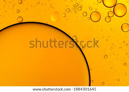 Golden bubbles. Yellow circles. Abstract background. Bubble oil on water. Macro-photography.