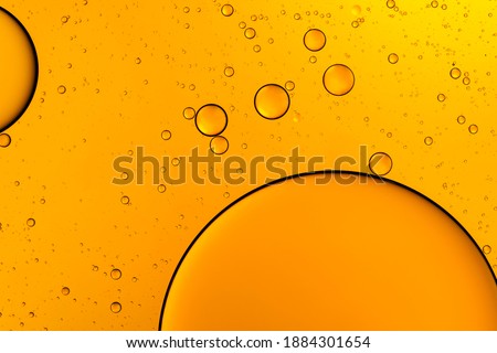 Golden bubbles. Yellow circles. Abstract background. Bubble oil on water. Macro-photography.