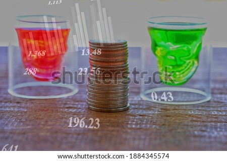 Coin stacks and Skull shaped glass with red and green water together with Stock market 
and forex trading graph and financial graph. business strategy as concept. brainstorm concept.
Abstract business