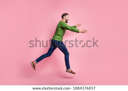 Full length body size profile side view of nice cheerful guy jumping running hugging copy space isolated over pink pastel color background Royalty-Free Stock Photo #1884376837