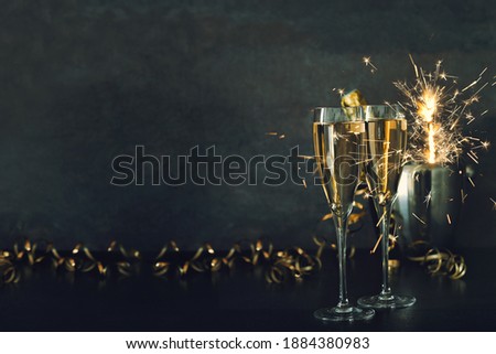 Two glasses Champagne with sparklers decoration. Vintage toned picture