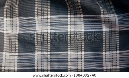 Inside blue tartan in a trench coat