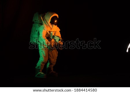 Isolated astronaut in the color spacesuit on black background