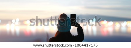 Rear view of adult modern woman traveller. Sunrise morning with cloud misty fog and city bokeh. Outdoor relax in nature concept. Banner background with copy space. Royalty-Free Stock Photo #1884417175