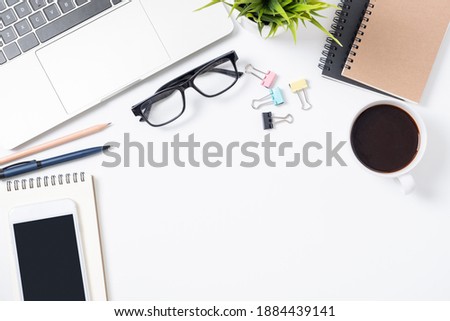 Flat lay of White office desk table or workplace with laptop, and smartphone and coffee cup with equipment other office supplies with copy space, top view