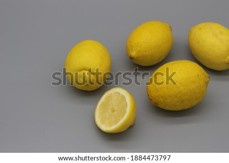 group of illuminating yellow lemons on the ultimate gray background. natural vitamin c