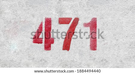Red Number 471 on the white wall. Spray paint.